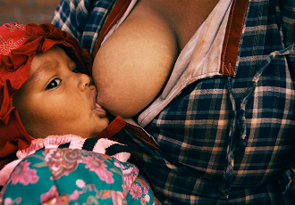 Mother breastfeeding daughter, Eugene, Oregon
